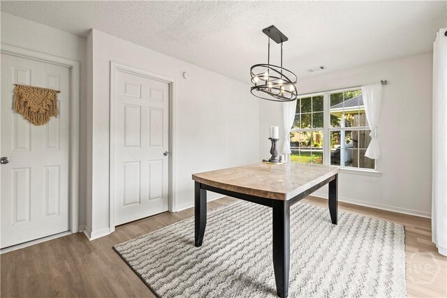 135 Trellis Way, Savannah, GA 31419 - dining area with light wood-style floors, a chandelier, and a textured ceiling
