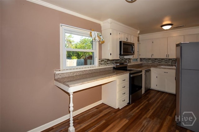 328 Riverview Dr, Savannah, GA 31404 - kitchen featuring stainless steel appliances, backsplash, white cabinets, dark wood-type flooring, and ornamental molding