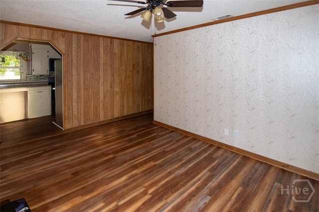 328 Riverview Dr, Savannah, GA 31404 - empty room with ceiling fan, dark wood-type flooring, crown molding, arched walkways, and a textured ceiling