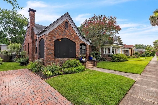 217 E 54th St, Savannah, GA 31405 - tudor house featuring brick siding and a chimney
