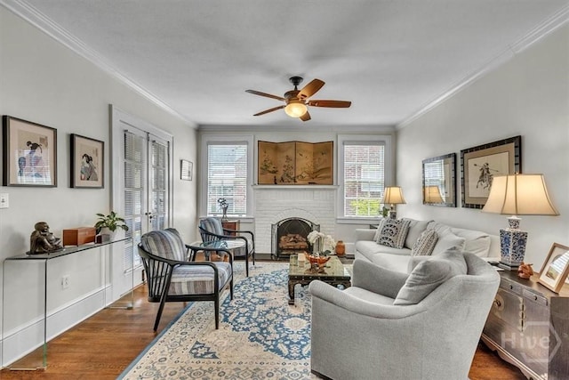217 E 54th St, Savannah, GA 31405 - living area with crown molding, healthy amount of natural light, ceiling fan, dark wood-style flooring, and a brick fireplace
