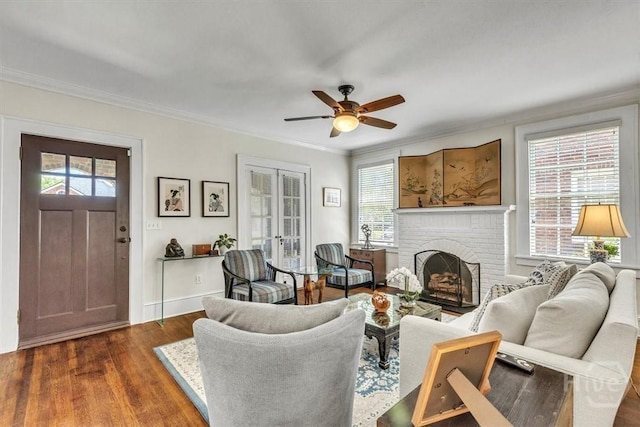 217 E 54th St, Savannah, GA 31405 - living room featuring dark wood-style flooring, healthy amount of natural light, a fireplace, ceiling fan, and crown molding
