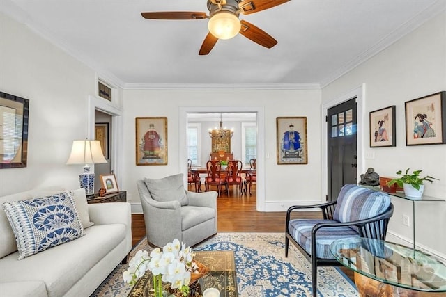 217 E 54th St, Savannah, GA 31405 - living room with a chandelier, wood finished floors, crown molding, and a ceiling fan