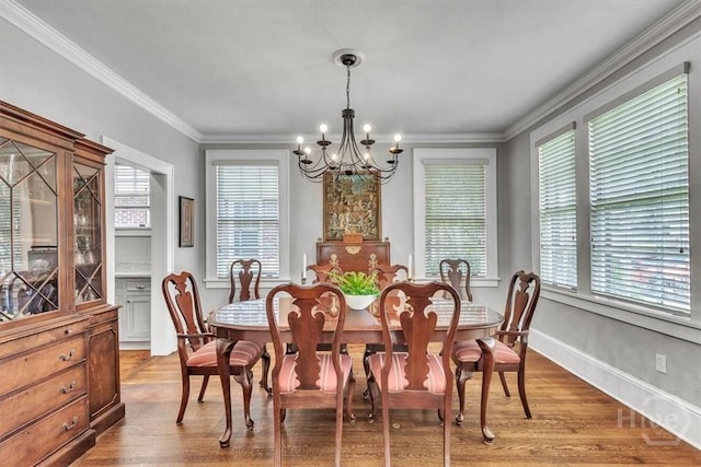 217 E 54th St, Savannah, GA 31405 - dining space with a chandelier, light wood-style floors, and crown molding