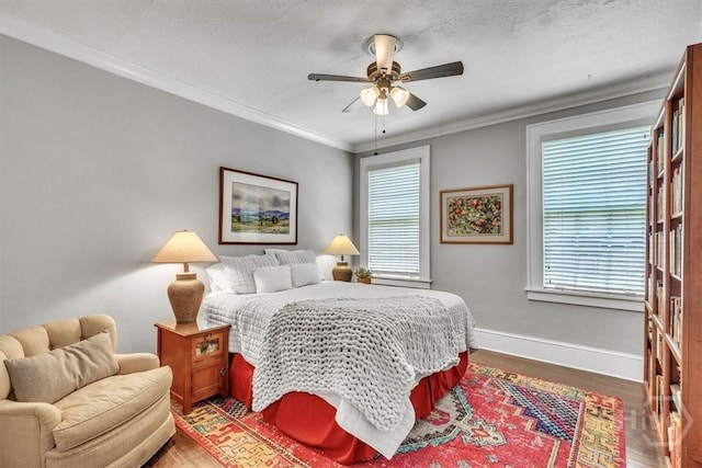 217 E 54th St, Savannah, GA 31405 - bedroom featuring wood finished floors, multiple windows, ornamental molding, and ceiling fan