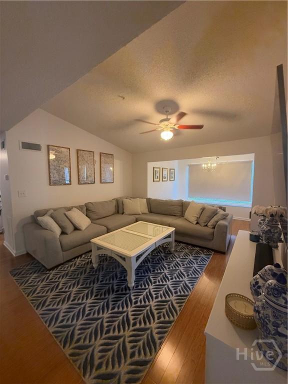 9307 Walden Park Dr, Savannah, GA 31410 - living area with wood finished floors, a ceiling fan, lofted ceiling, and a textured ceiling