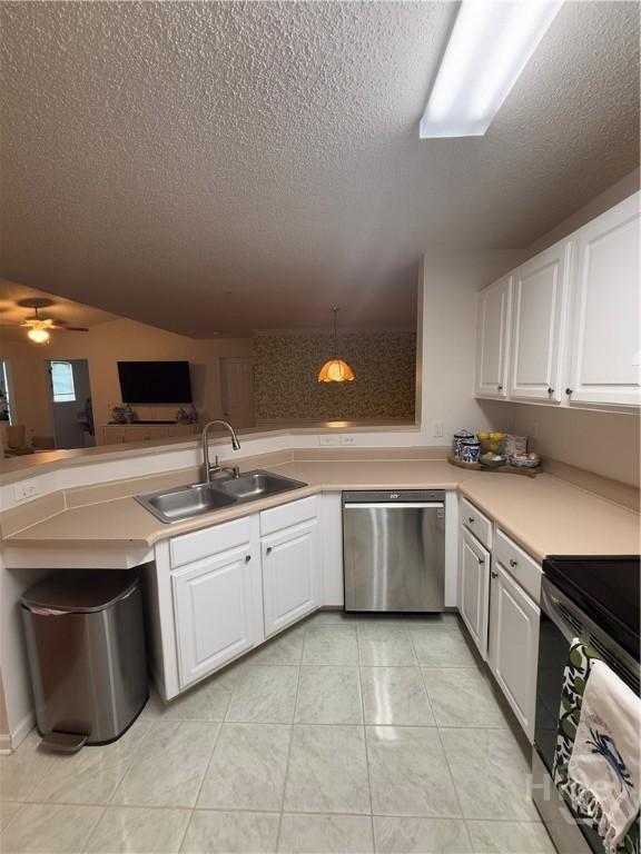 9307 Walden Park Dr, Savannah, GA 31410 - kitchen featuring dishwasher, a textured ceiling, range, white cabinets, and light countertops