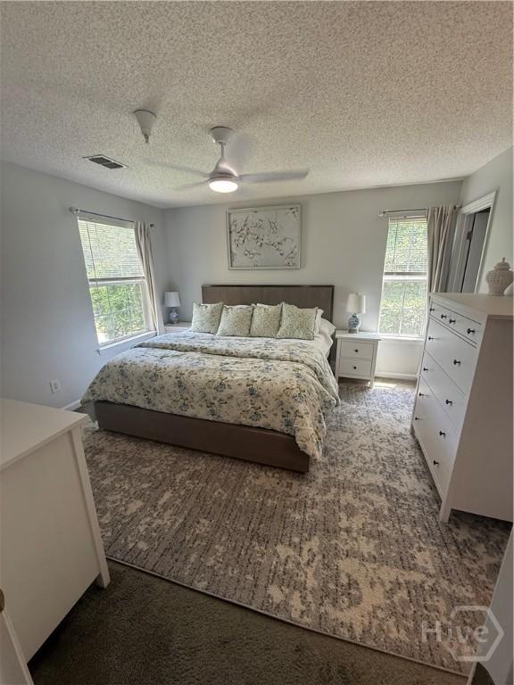 9307 Walden Park Dr, Savannah, GA 31410 - carpeted bedroom with a textured ceiling and a ceiling fan
