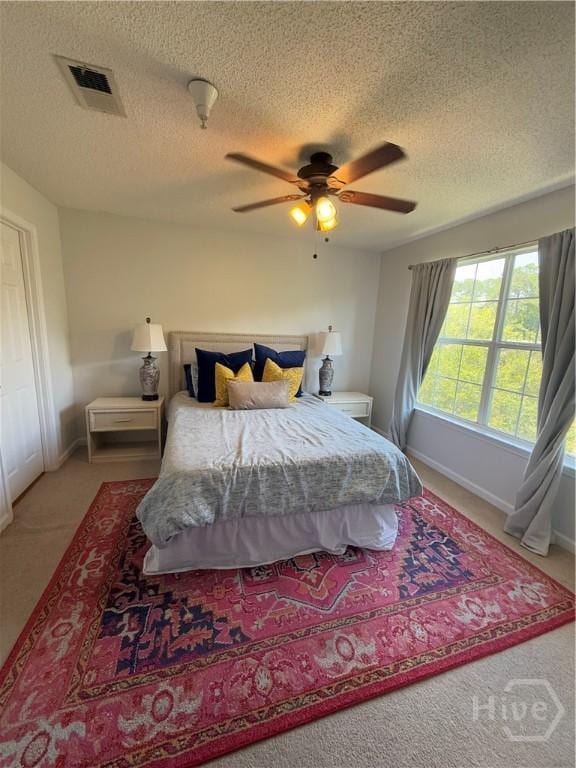 9307 Walden Park Dr, Savannah, GA 31410 - bedroom featuring a textured ceiling, carpet, and a ceiling fan