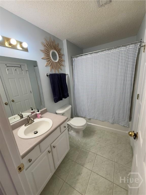 9307 Walden Park Dr, Savannah, GA 31410 - full bath with vanity, a textured ceiling, tile patterned floors, and shower / tub combo
