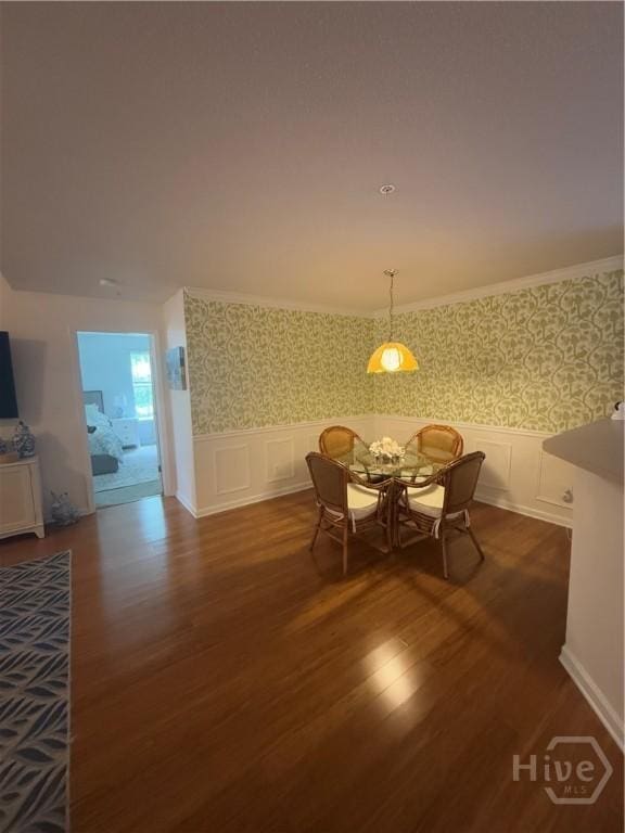 9307 Walden Park Dr, Savannah, GA 31410 - dining area featuring wood finished floors, wallpapered walls, wainscoting, and a decorative wall