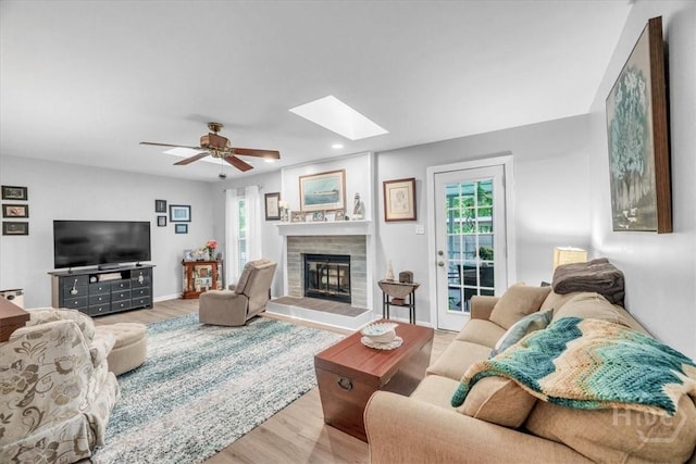 13 Bryan Wood Cir, Savannah, GA 31410 - living area with wood finished floors, plenty of natural light, a skylight, recessed lighting, and a tiled fireplace