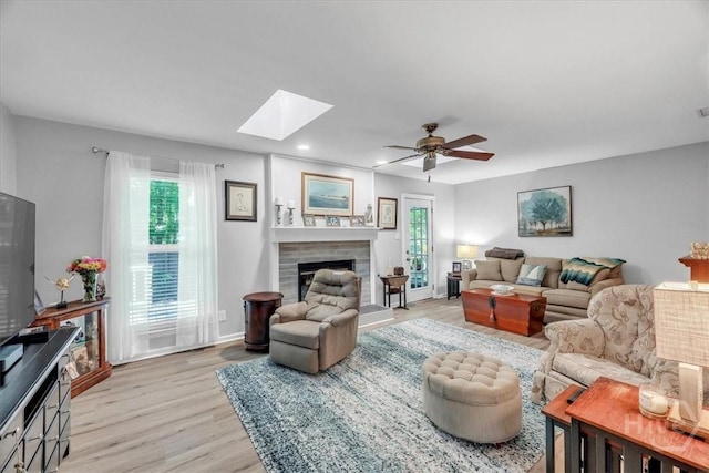13 Bryan Wood Cir, Savannah, GA 31410 - living room featuring a skylight, healthy amount of natural light, light wood finished floors, ceiling fan, and recessed lighting