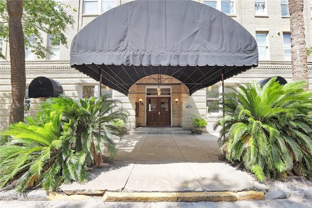 106 W Gwinnett St Unit 4D, Savannah, GA 31401 - view of exterior entry with brick siding and french doors