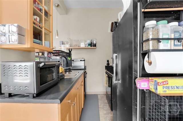 106 W Gwinnett St Unit 4D, Savannah, GA 31401 - kitchen featuring black fridge, glass insert cabinets, stove, dark countertops, and tile patterned flooring