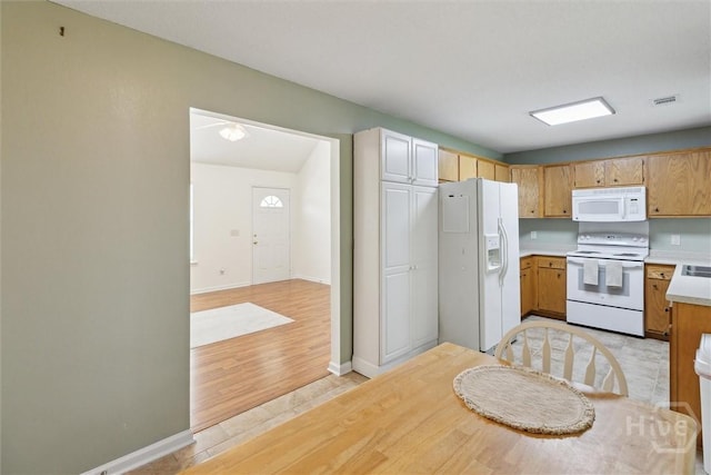 281 Barrister Cir, Guyton, GA 31312 - kitchen with white appliances, light countertops, and light wood-style floors