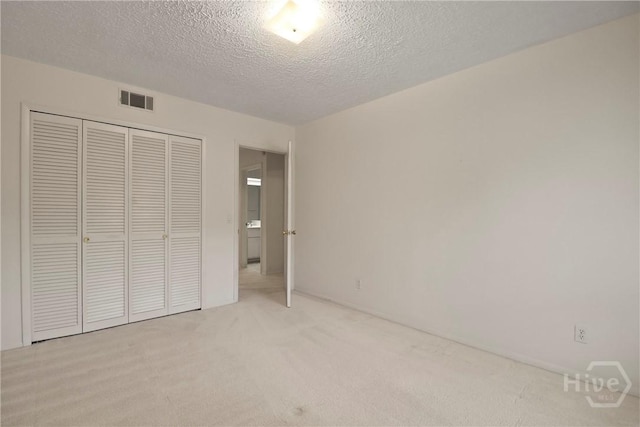 10804 Dorchester Rd, Savannah, GA 31406 - unfurnished bedroom with light carpet, a closet, and a textured ceiling