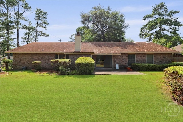 10804 Dorchester Rd, Savannah, GA 31406 - rear view of property with a patio area, a lawn, a chimney, and brick siding