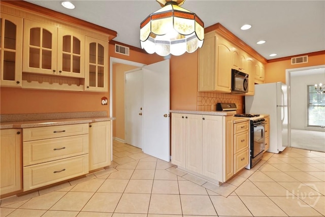 10804 Dorchester Rd, Savannah, GA 31406 - kitchen featuring range with gas stovetop, black microwave, light countertops, glass insert cabinets, and recessed lighting