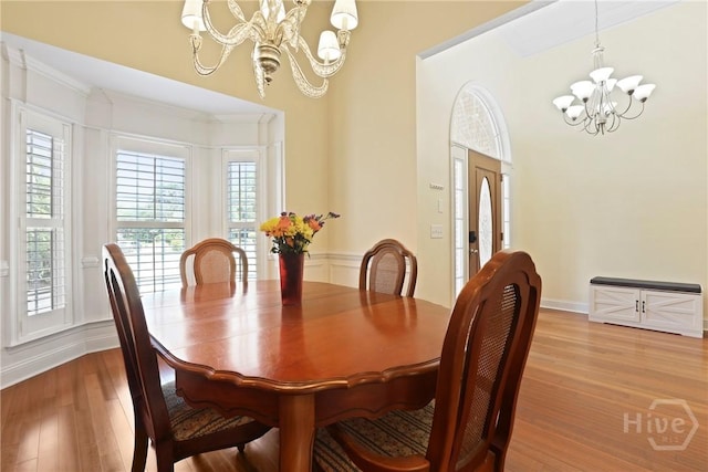 72 Roswell Trl, Richmond Hill, GA 31324 - dining area with a chandelier, light wood-type flooring, and crown molding