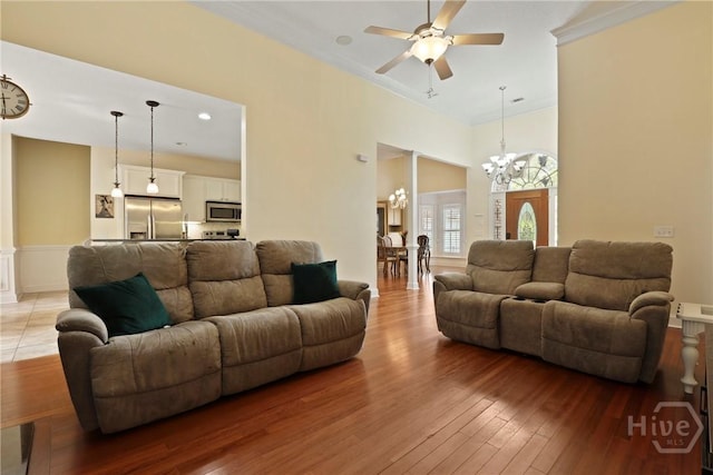 72 Roswell Trl, Richmond Hill, GA 31324 - living area featuring light wood-style floors, a chandelier, a ceiling fan, and crown molding