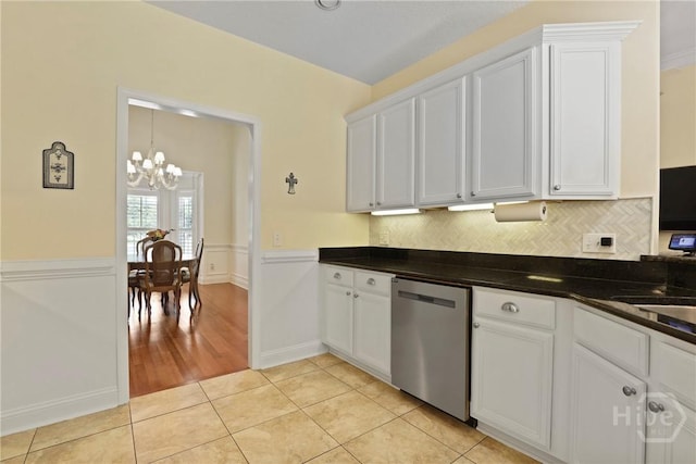72 Roswell Trl, Richmond Hill, GA 31324 - kitchen with stainless steel dishwasher, a chandelier, white cabinetry, dark countertops, and a wainscoted wall