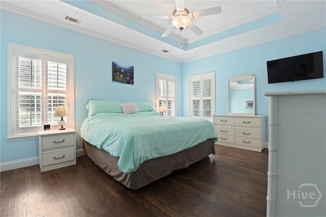 72 Roswell Trl, Richmond Hill, GA 31324 - bedroom with dark wood-style floors, multiple windows, a raised ceiling, ornamental molding, and ceiling fan
