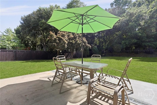 72 Roswell Trl, Richmond Hill, GA 31324 - fenced backyard with outdoor dining space, a patio, and view of wooded area