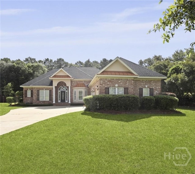 72 Roswell Trl, Richmond Hill, GA 31324 - view of front of home featuring a front lawn, concrete driveway, and brick siding