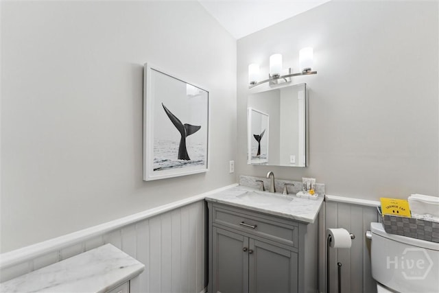 531 E Broad St, Savannah, GA 31401 - half bath featuring a wainscoted wall, vanity, and a decorative wall
