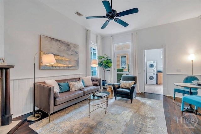 531 E Broad St, Savannah, GA 31401 - living area with a wainscoted wall, ceiling fan, hardwood / wood-style flooring, and stacked washer / dryer