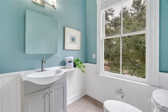 531 E Broad St, Savannah, GA 31401 - half bathroom with vanity, a decorative wall, a wainscoted wall, and plenty of natural light