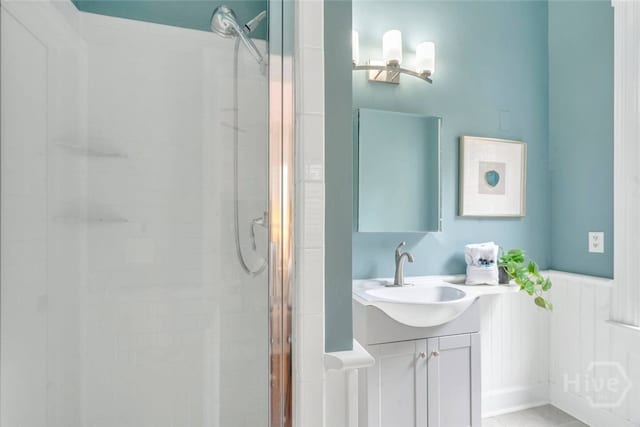 531 E Broad St, Savannah, GA 31401 - bathroom featuring a stall shower, vanity, and wainscoting