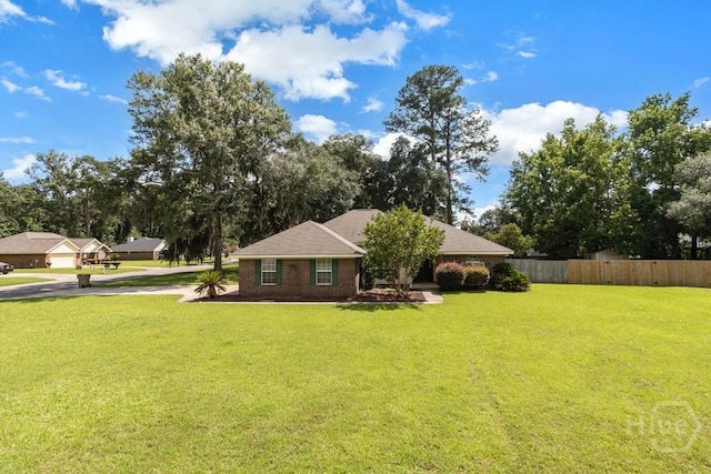 633 Greenwich Dr, Richmond Hill, GA 31324 - view of front of home with driveway and view of wooded area