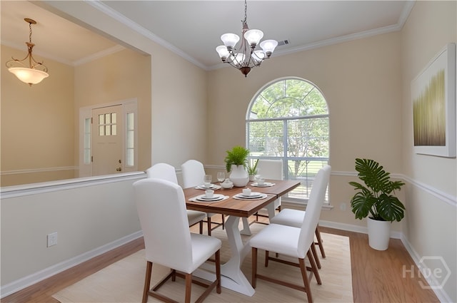 633 Greenwich Dr, Richmond Hill, GA 31324 - dining space with light wood-style floors, a chandelier, and ornamental molding