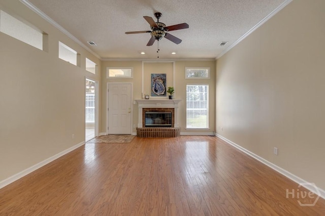 633 Greenwich Dr, Richmond Hill, GA 31324 - unfurnished living room featuring healthy amount of natural light, ceiling fan, a textured ceiling, light wood-type flooring, and crown molding