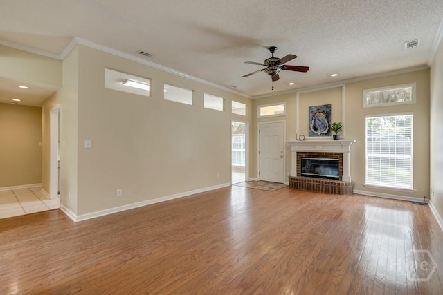 633 Greenwich Dr, Richmond Hill, GA 31324 - unfurnished living room featuring a ceiling fan, crown molding, light wood finished floors, a brick fireplace, and recessed lighting