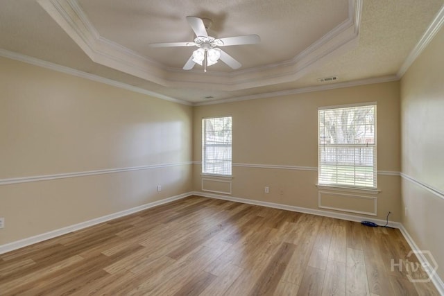 633 Greenwich Dr, Richmond Hill, GA 31324 - empty room featuring a raised ceiling, light wood-style floors, a ceiling fan, and ornamental molding