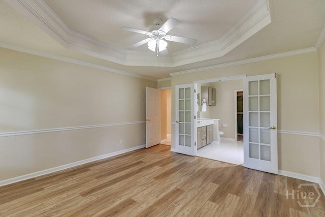 633 Greenwich Dr, Richmond Hill, GA 31324 - empty room with french doors, a raised ceiling, ornamental molding, light wood-style flooring, and ceiling fan