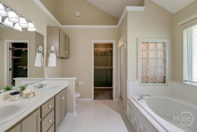 633 Greenwich Dr, Richmond Hill, GA 31324 - bathroom featuring vaulted ceiling, a walk in closet, a bath, double vanity, and healthy amount of natural light