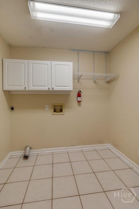 633 Greenwich Dr, Richmond Hill, GA 31324 - laundry room with cabinet space, hookup for a washing machine, hookup for an electric dryer, and light tile patterned floors