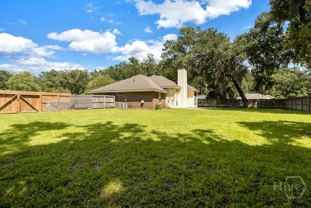 633 Greenwich Dr, Richmond Hill, GA 31324 - rear view of house with a fenced backyard, a chimney, and brick siding