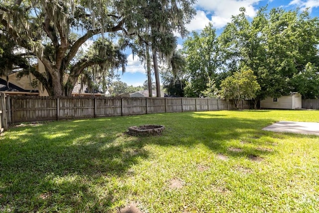 633 Greenwich Dr, Richmond Hill, GA 31324 - fenced backyard featuring an outdoor fire pit and a storage unit
