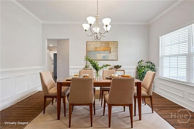 131 Guana Ln, Bloomingdale, GA 31302 - dining space featuring ornamental molding, a chandelier, a decorative wall, plenty of natural light, and wainscoting