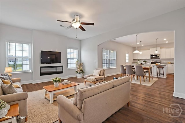 131 Guana Ln, Bloomingdale, GA 31302 - living area featuring arched walkways, healthy amount of natural light, a ceiling fan, dark wood-type flooring, and recessed lighting