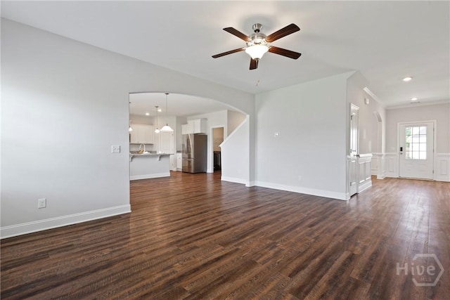 131 Guana Ln, Bloomingdale, GA 31302 - unfurnished living room with arched walkways, a ceiling fan, dark wood finished floors, and recessed lighting