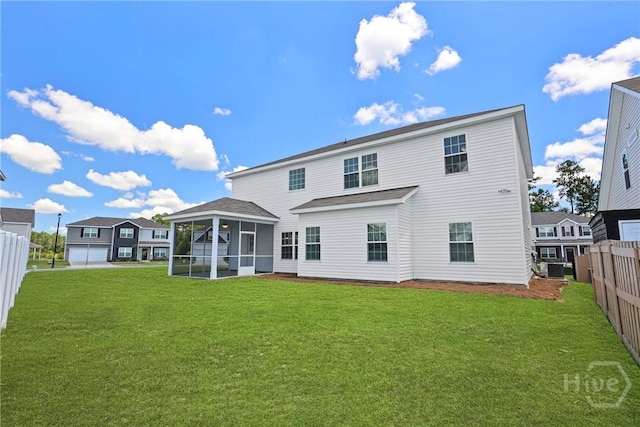 131 Guana Ln, Bloomingdale, GA 31302 - rear view of property with a sunroom and a fenced backyard