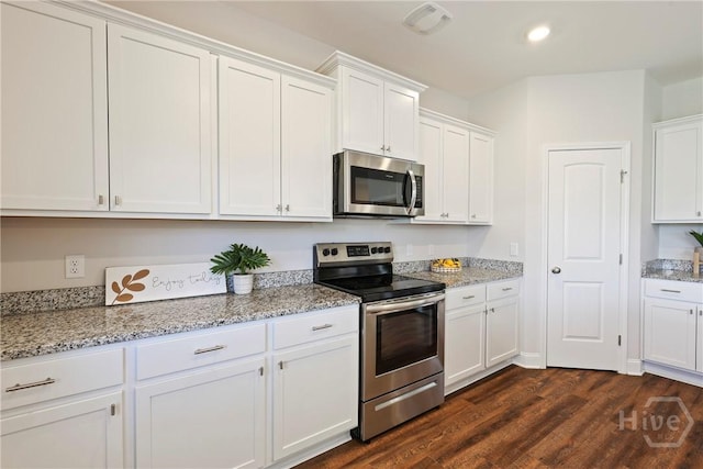 131 Guana Ln, Bloomingdale, GA 31302 - kitchen featuring appliances with stainless steel finishes, white cabinetry, dark wood-style floors, light stone counters, and recessed lighting