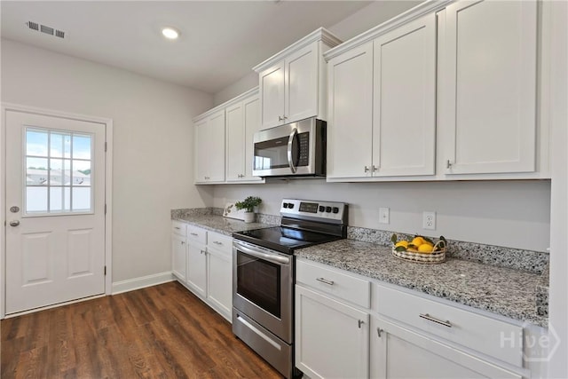 131 Guana Ln, Bloomingdale, GA 31302 - kitchen featuring stainless steel appliances, white cabinetry, dark wood-style flooring, light stone counters, and recessed lighting