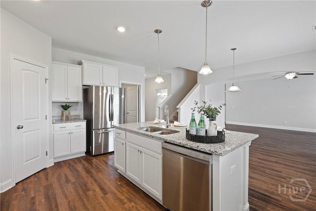 131 Guana Ln, Bloomingdale, GA 31302 - kitchen with stainless steel appliances, ceiling fan, dark wood finished floors, white cabinets, and a kitchen island with sink